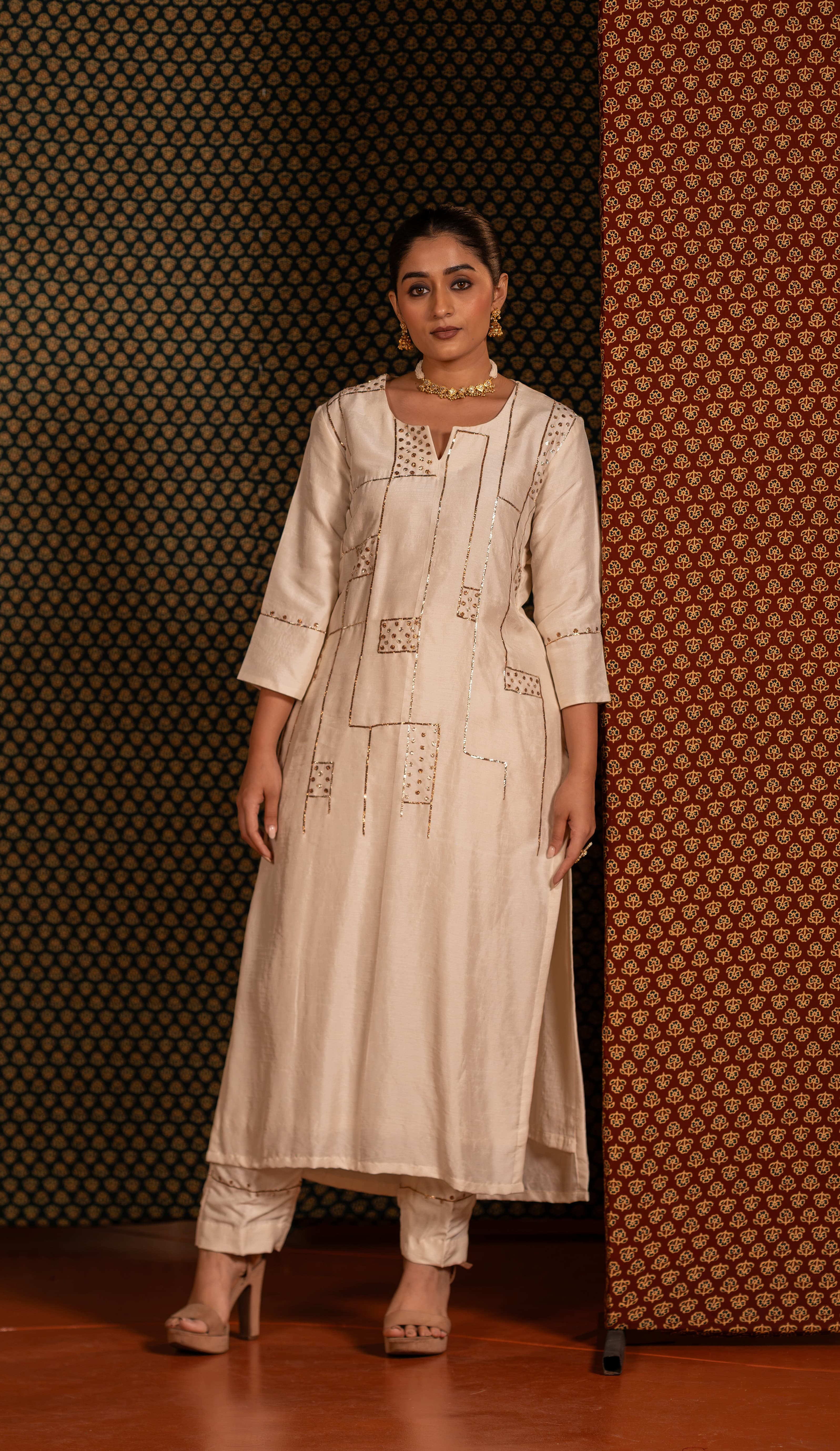 Off-white kurta set detailed with traditional Pitta handwork