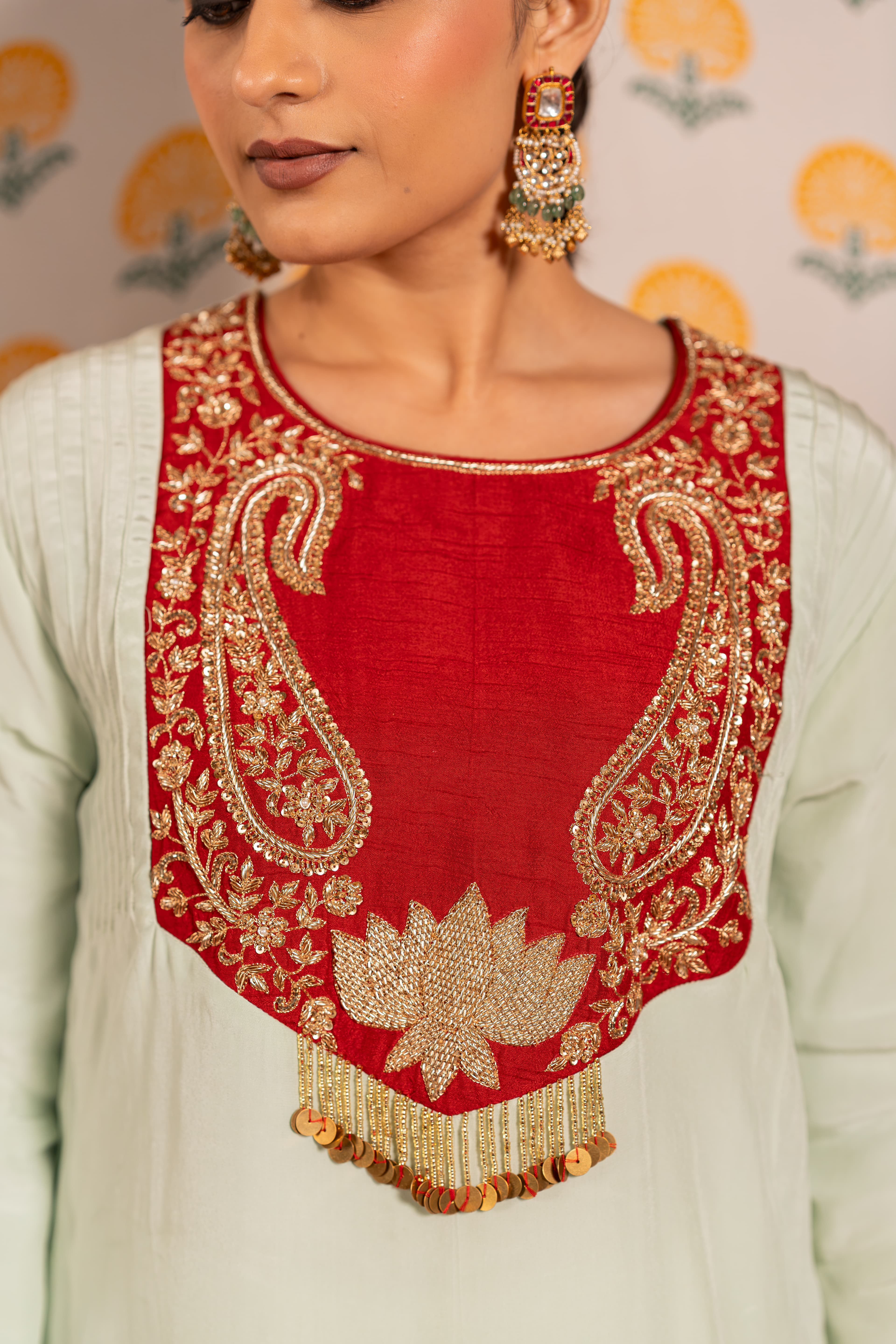 Craftsmanship detail — Pista green with red yoke Aline kurta set