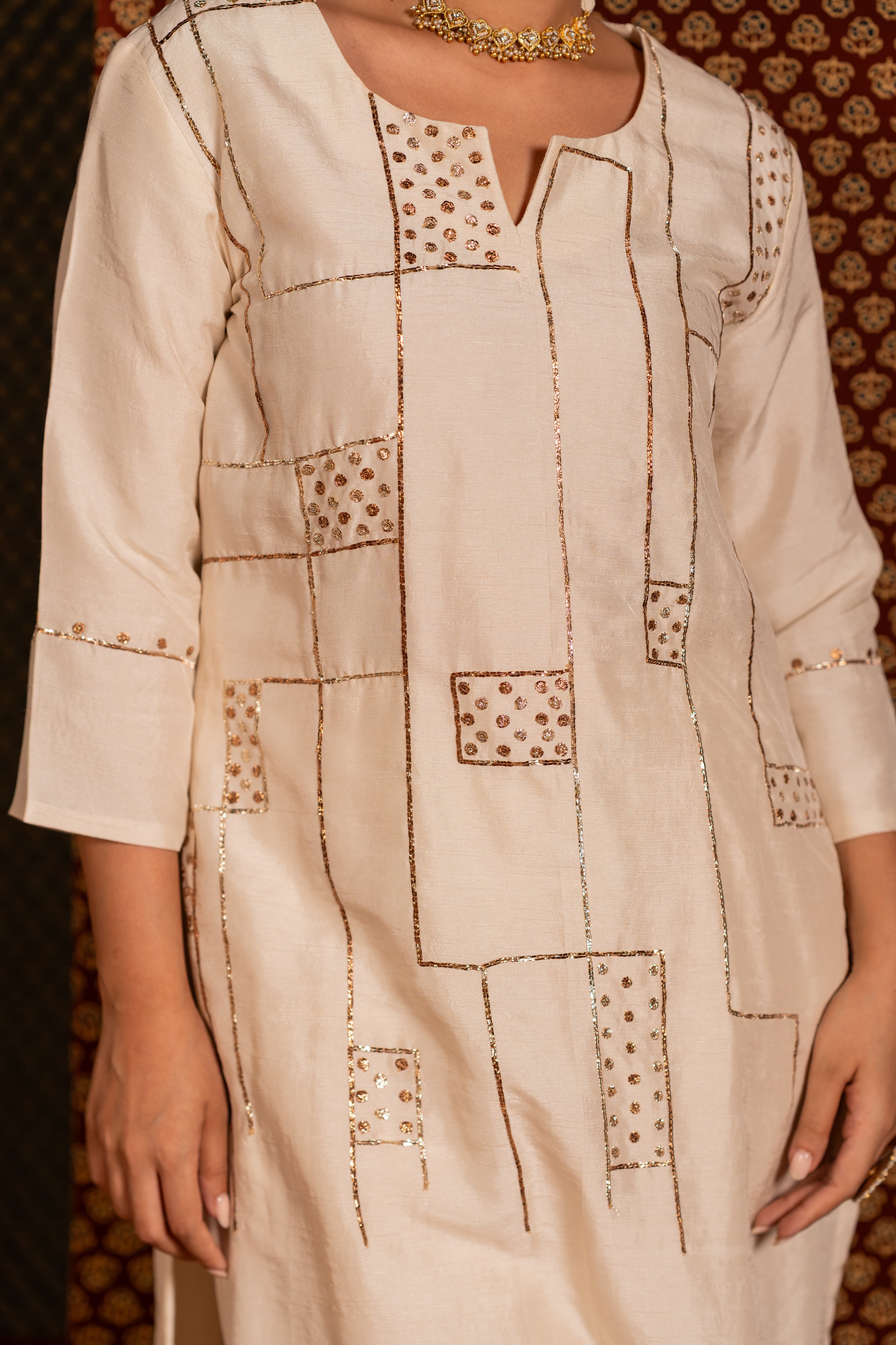 Craftsmanship detail — Off-white kurta set detailed with traditional Pitta handwork